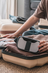Fototapeta premium woman exploring a city in virtual reality, wearing VR goggles and carrying a suitcase, blending technology with the travel experience. The concept of VR travel and digital nomad lifestyle 
