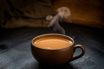 A close-up of warm, golden Mexican Atole against a dark background