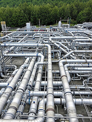 Large Metallic Pipes in Complex Arrangements at Oil Refinery Adjacent to Forested Region