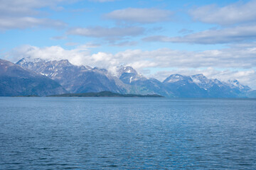 Snowy mountains, fjord and blue sky in Norwegian landscape in Olderdalen, Norway