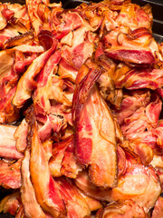 Close up view of a tray with many pieces of crispy bacon