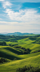 Obraz premium Lush green hills stretch into distance under vibrant blue sky