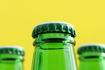 Three closed green glass bottles