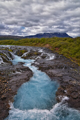 Bruarfoss or Bridge Falls, small hidden waterfall blue striking color, Iceland’s Bluest Waterfall, along Bruara river. Golden Circle South Iceland