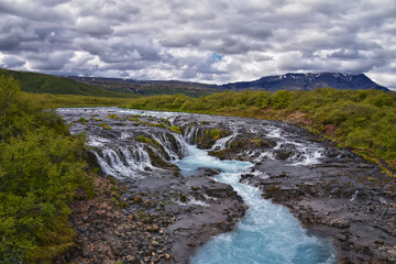 Bruarfoss or Bridge Falls, small hidden waterfall blue striking color, Iceland’s Bluest Waterfall, along Bruara river. Golden Circle South Iceland