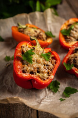 Stuffed peppers with herbs and cheese on the rustic background. Selective focus. Shallow depth of field.