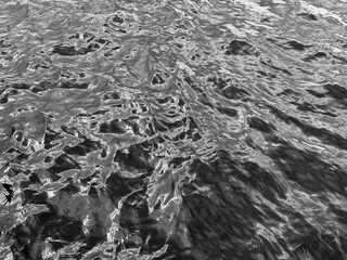 Dark gray silver glittering water background.