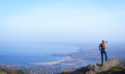 Hiker on the road to Santiago. Coastal path or Northern path on the Jaizkibel mountain, Euskadi
