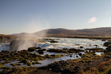 A tranquil Icelandic river meandering through the rugged landscape, surrounded by mountains