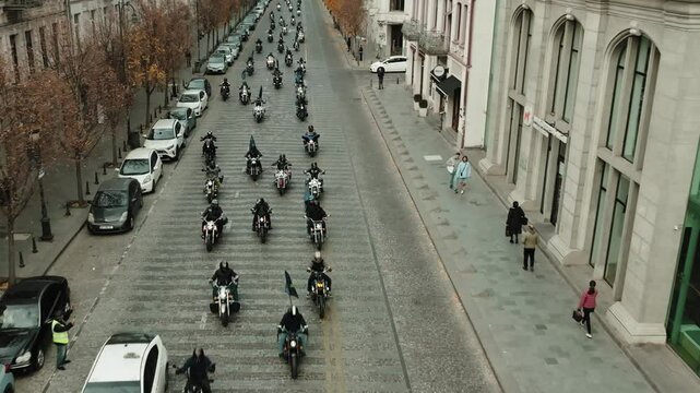 Thousands of bikers rev their engines in a thrilling motorcycle parade, showcasing their helmets and gear at the biker show  