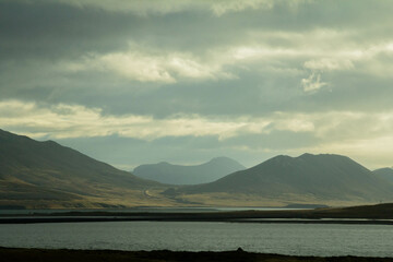 Majestic Icelandic mountains rise above the sea, offering a stunning view