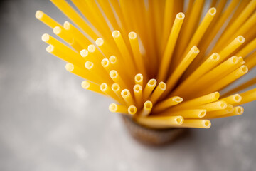 Raw dry spaghetti on the rustic wooden background. Selective focus.