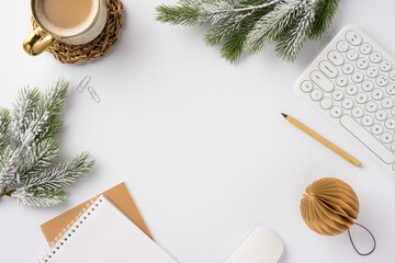 Top view of a winter-themed workspace featuring a coffee cup, keyboard, notebook, and festive decor...