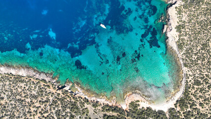 Aerial drone photo from tropical exotic paradise secluded rocky island bay with deep turquoise sea...