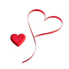 Red ribbon heart and a small red heart-shaped figurine. Simple and elegant design.