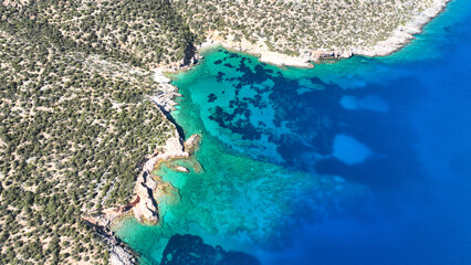 Aerial drone photo from tropical exotic paradise secluded rocky island bay with deep turquoise sea forming a blue lagoon visited by yachts and sail boats in Caribbean exotic destination