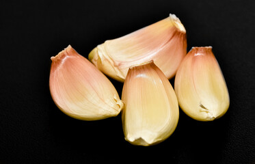 photos of garlic on a black background