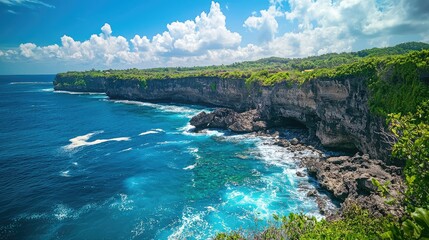 Obraz premium Breathtaking Coastal Landscape with Rocky Cliffs and Turquoise Waters Under a Vibrant Blue Sky with Fluffy White Clouds in a Tropical Paradise