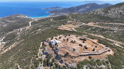 Aerial drone photo of archaeological site of the Mycenaean Citadel and chapel of Agios Andreas built on top of hill overlooking the Aegean sea, Sifnos island, Cyclades, Greece