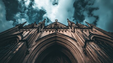 Fototapeta premium Gothic Architecture Against Dramatic Sky: Detailed View of Cathedral Facade with Intricate Spires and Cloudy Atmosphere Showcase Timelessness of Historical Structures
