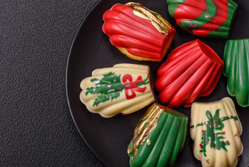 Sweet Madeleines desserts covered with chocolate in Christmas colors