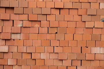 Close-up of perforated bricks stacked at the construction site.