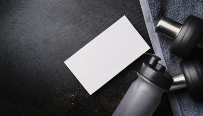 Business card mock up on gym towel with dumbbells and water bottle in fitness setting