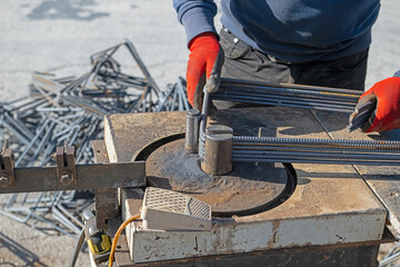 Ironworker preparing various sizes of iron for building construction.