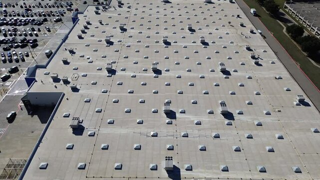 Extra-large grocery store with busy parking cars customer walking in and out, packaged units RTU on flat roof, HVAC conditioning cooling, dehumidifying, heating, heat pump, air handlers, flyover