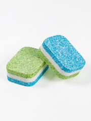 Tablets for washing dishes in the dishwasher. Two tablets isolated on a white background.