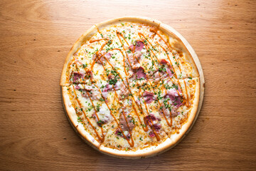 BBQ pulled pork pizza topped with tender pulled pork, BBQ sauce, and melted cheese served on wooden board isolated on table background top view of italian cousin