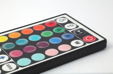 A remote control for rgb lights on a white background. Used to control the color of the rgb led lights in a room, terrace, garage, or living room.