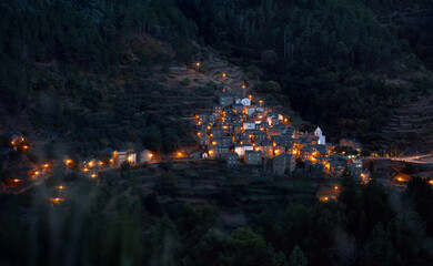 night view of the lights of small city in the mountains 