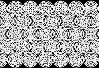Fabric of white circles, on a black background, crochet, symmetrical pattern.