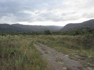 A beautiful view from the top of Serra do Cipó of a rain coming in the distance high in the mountains