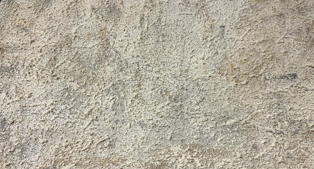 Rough textured beige wall close-up with natural uneven patterns, ideal for use as a background in architectural, interior design, or construction-related projects, emphasizing rustic and earthy aesthe