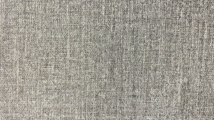 Textured gray fabric background with a detailed woven pattern. Perfect for use in upholstery design, textile catalogs, fabric industry promotions, or minimalistic graphic design projects.