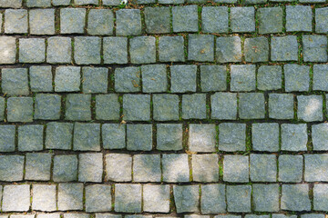 Path in the park laid out of cubic natural stone. Interesting textured image