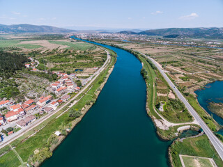 Neretva River and Valley Landscape with Green Hills and Village in Southern Croatia