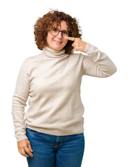 Beautiful middle ager senior woman wearing turtleneck sweater and glasses over isolated background Pointing with hand finger to face and nose, smiling cheerful