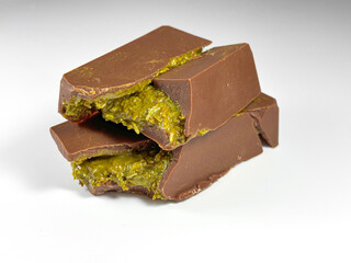 On white background lies Dubai chocolate with pistachio paste and kataifi dough