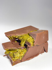 On white background lies Dubai chocolate with pistachio paste and kataifi dough