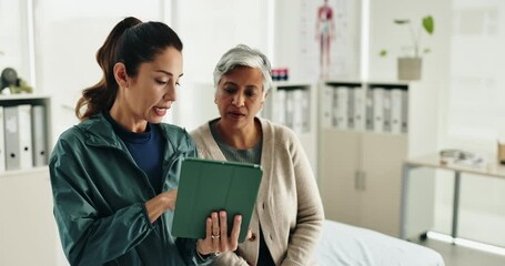 Senior woman, physiotherapy and tablet for recovery, notes or review with app for advice at clinic. Doctor, patient and touchscreen with report, progress or rehabilitation with discussion at hospital