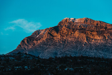 Fototapeta premium Golden Hour View of Majestic Mountain in Southern Croatia with Snow-Capped Peaks