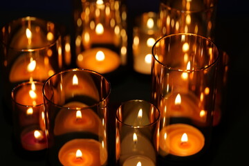 Teelichter brennen in hohen Gläsern und erleuchten den Raum, schöne Dekoration zur Adventszeit