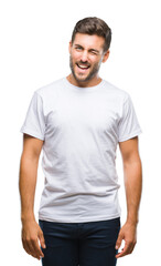 Young handsome man over isolated background winking looking at the camera with sexy expression, cheerful and happy face.