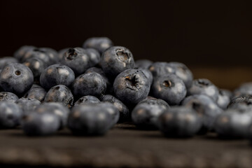 a pile of blueberries scattered on the board
