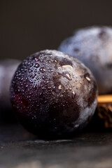 close-up of purple plum fruits in drops of water