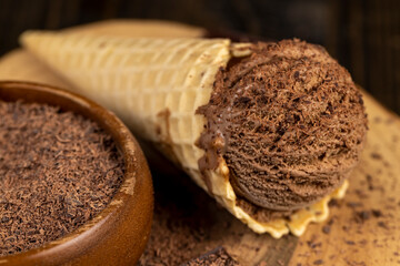 chocolate ice cream in a cone on a board