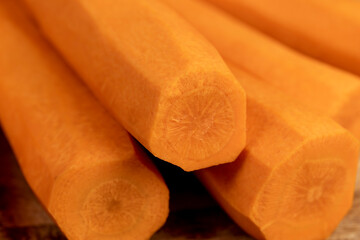 peeled orange carrots on the table during cooking
